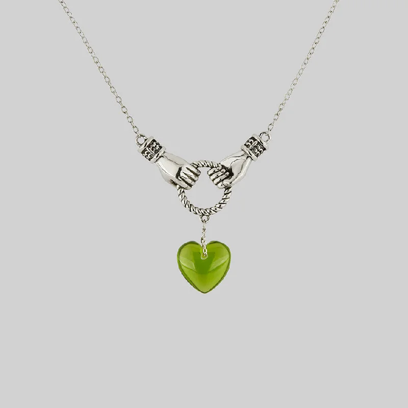 Knotted cord necklace-UNITE. Hand Grasping Green Glass Heart Necklace - Silver